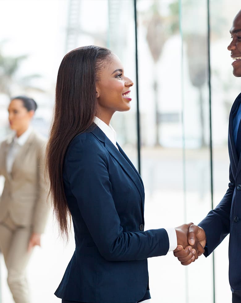 Professionals shaking hands in a modern office